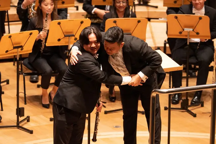 Two VENTUS musicians embracing on stage after the SIBF performance